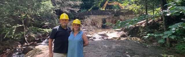 Woods Lodge Owners with dam prior to removal